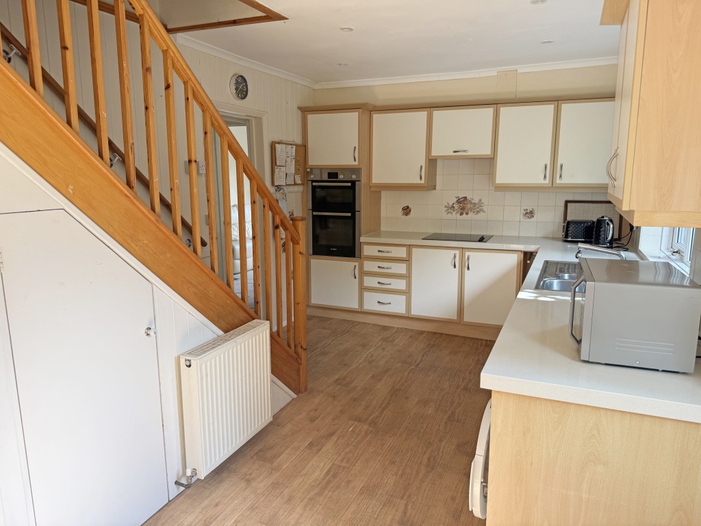 Lot: 122 - DETACHED BUNGALOW WITH ROOF CONVERSION AND POTENTIAL - Ground floor kitchen with stairs to first floor